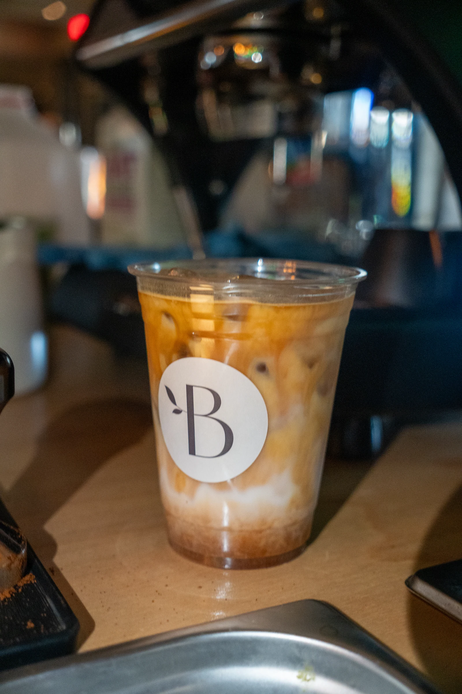 Espresso swirling into milk in a Bloom iced latte